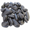 A pile of smooth, polished black tumbled stones, likely river rocks or spa stones, arranged on a plain white background.