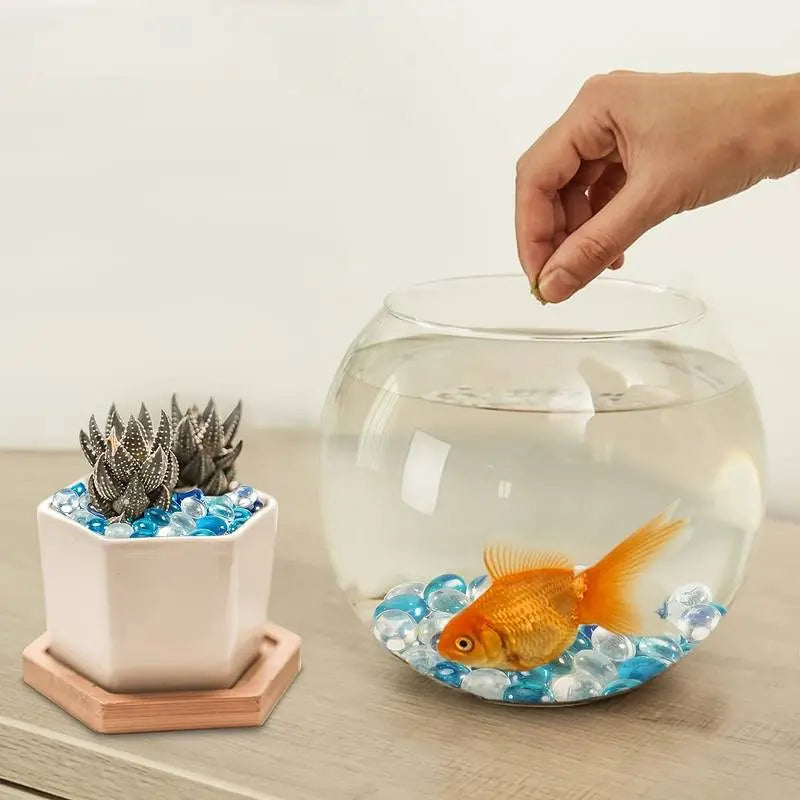 Stoned clear and turquoise decorative stones used in a fishbowl with goldfish and a plant pot decoration