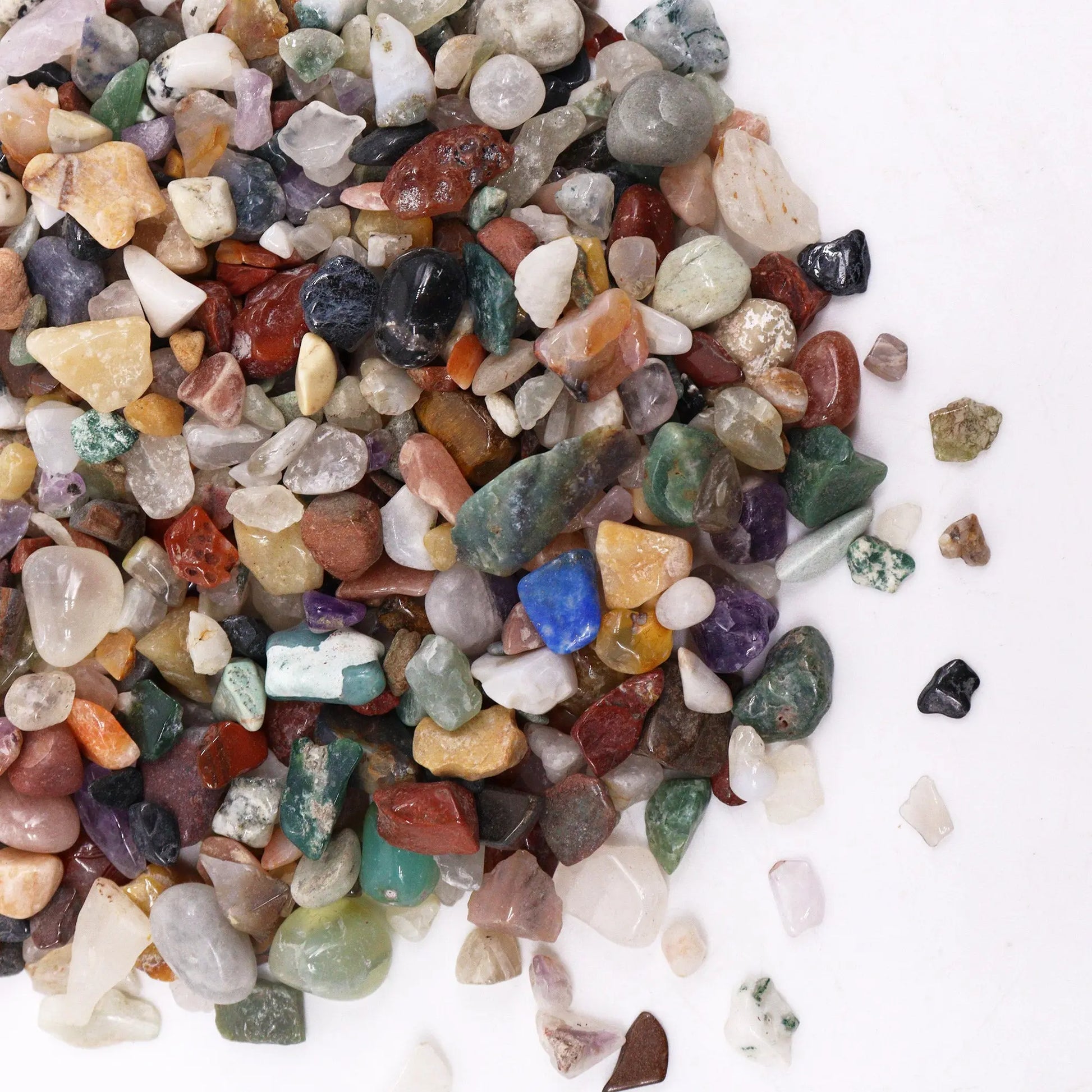 Colorful polished mixed gemstone crystal chips from SGI Online on a white background