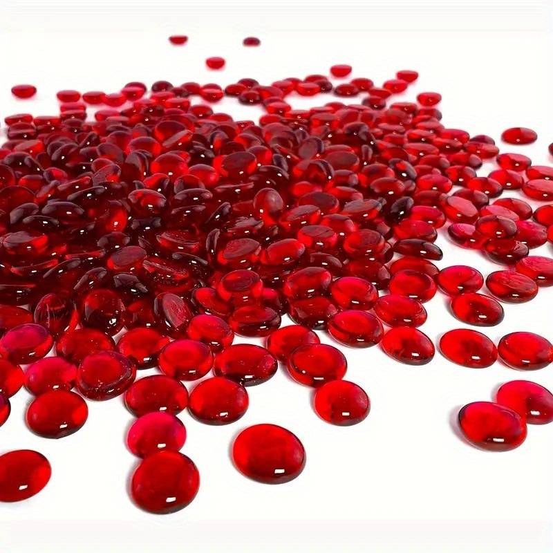 Shiny red glass pebbles bulk from STONED brand spread on a white surface for decoration