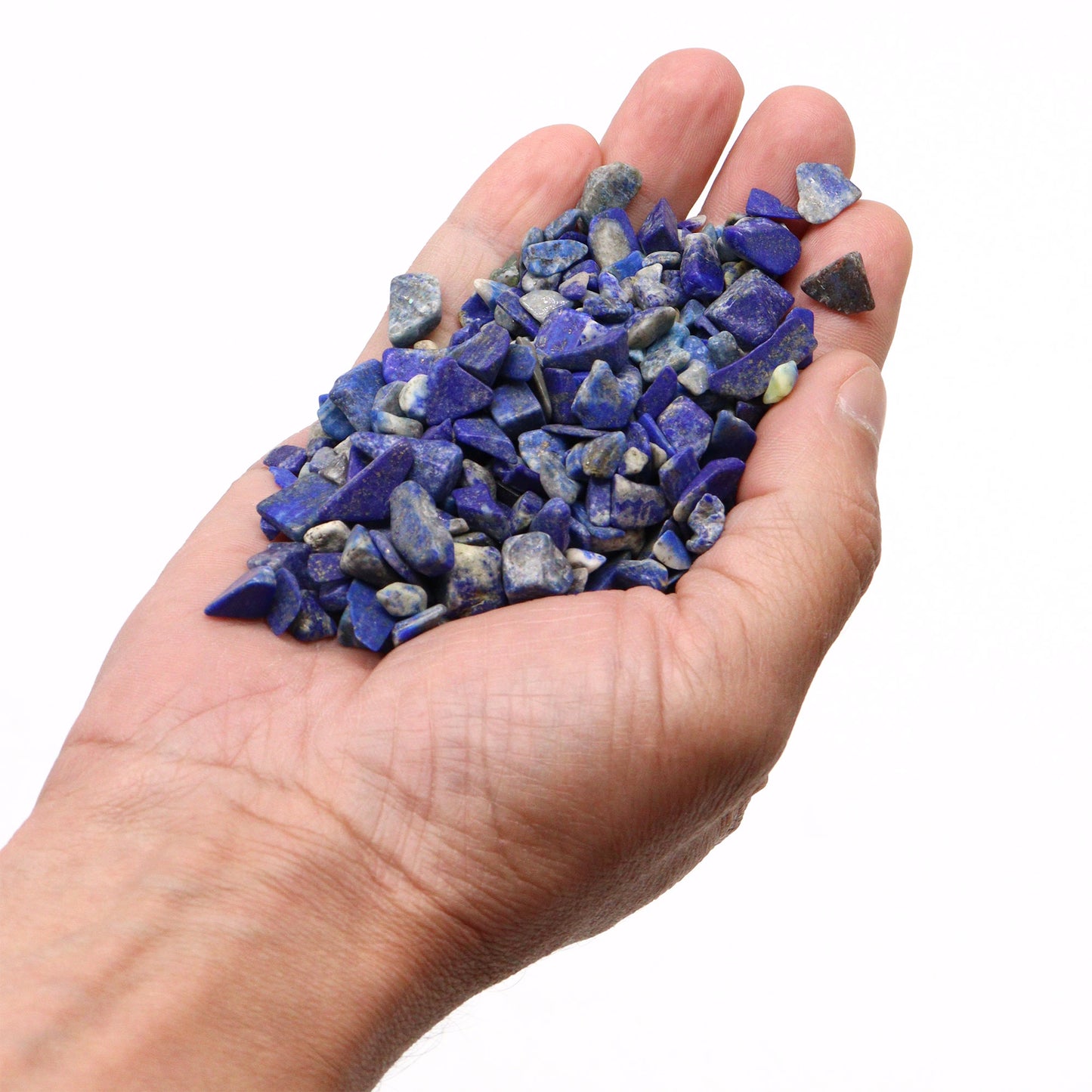 Hand holding polished lapis gemstone chips in vibrant blue with natural patterns by SGI Online SGI Online