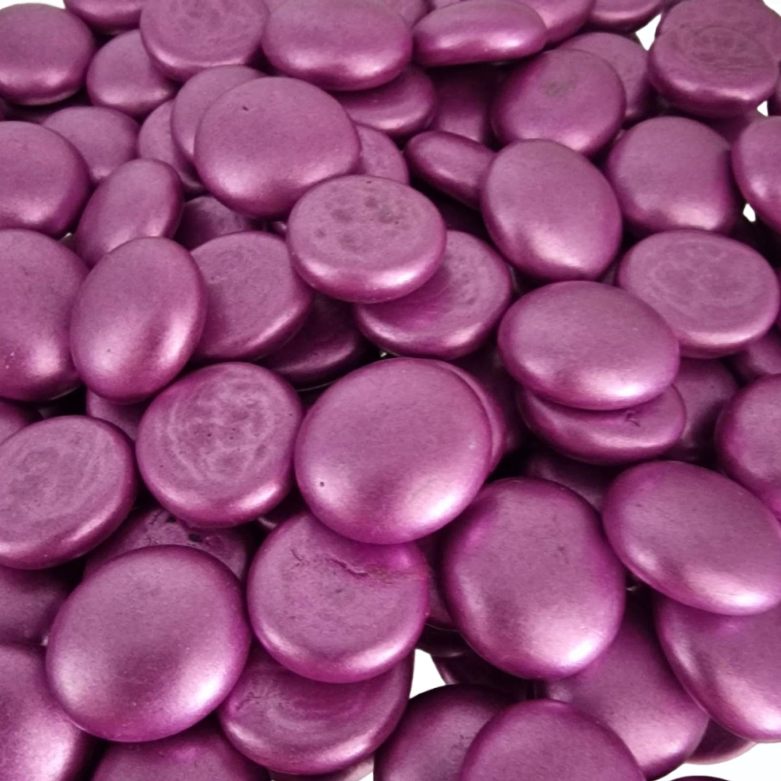 Close-up of metallic pink glass pebbles by STONED decorative smooth shiny stones