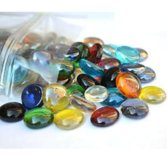 Colorful decorative glass pebbles for home decor spilling out of a clear plastic bag by STONED SGI Online