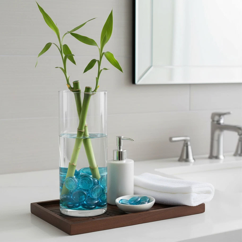 STONED turquoise glass pebbles in clear glass vase with bamboo on wooden tray in bathroom