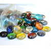 ST0NED 15kg decorative glass pebbles in various colors spilled from a clear plastic bag