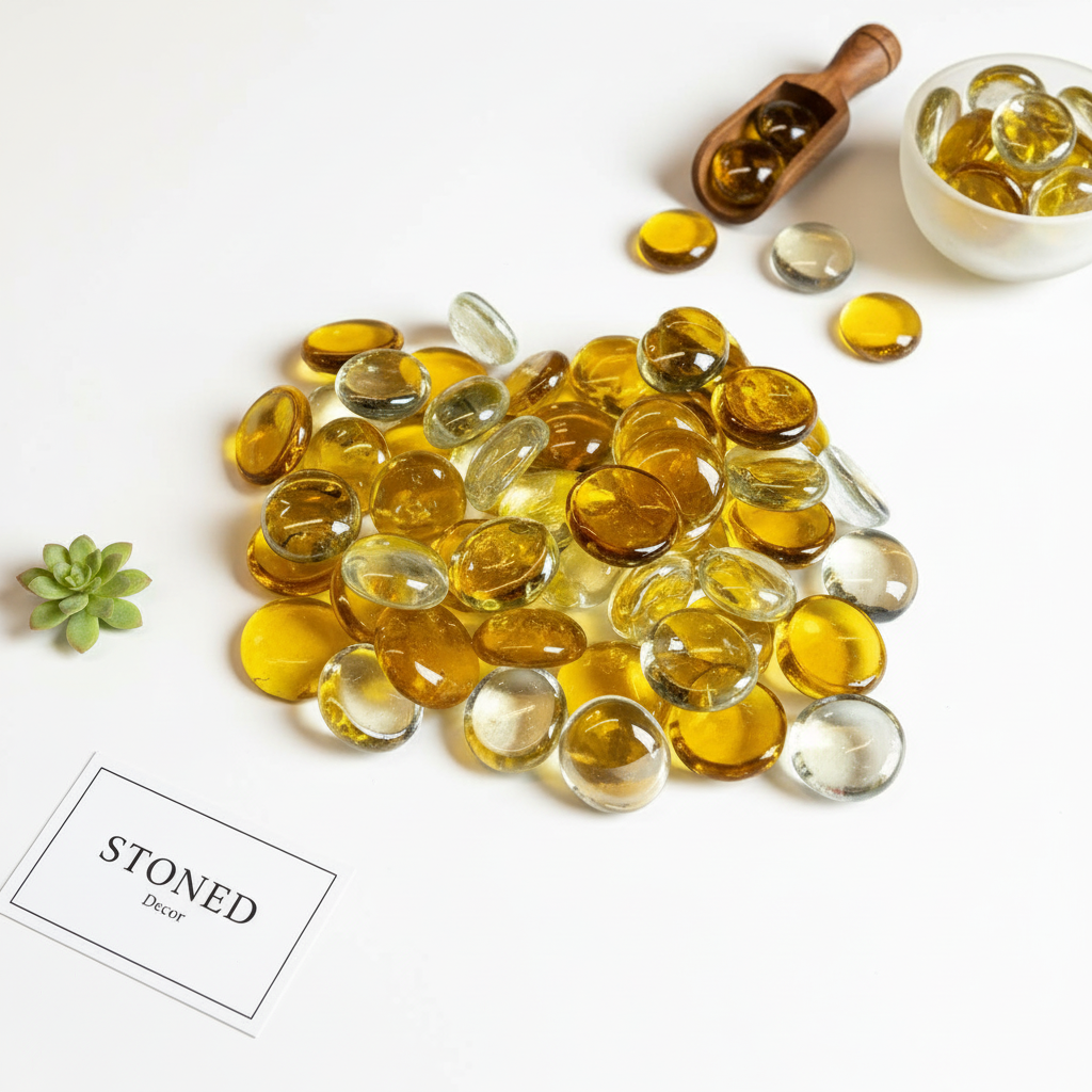 STO NED yellow and clear glass pebbles scattered on white surface with wooden scoop and small bowl
