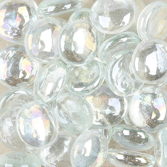 Close-up of STONED clear iridescent glass pebbles with smooth glossy surfaces reflecting light SGI Online