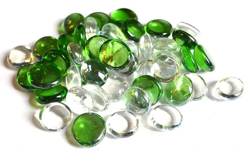STONED green and clear glass pebbles scattered on a white background for decoration
