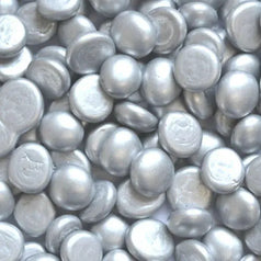 Close-up view of metallic silver glass pebbles by STONED for decorative and craft use