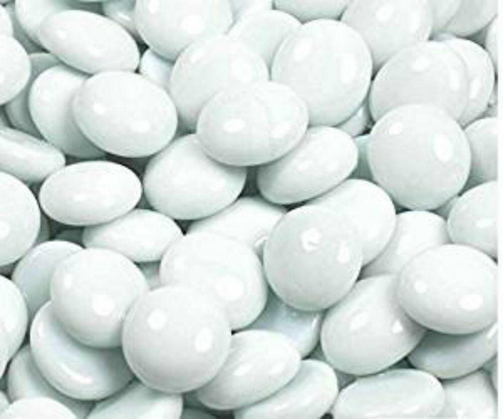 Close-up of white glass pebbles 15kg by STONED smooth and glossy decorative stones